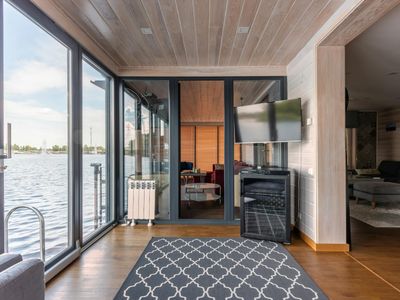 An empty, minimalistic room with natural light from a window.